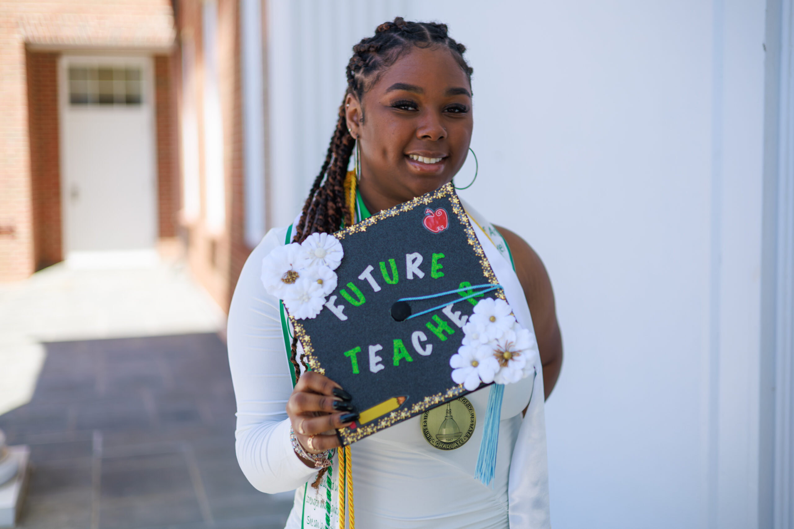 A student holding a graduation cap  