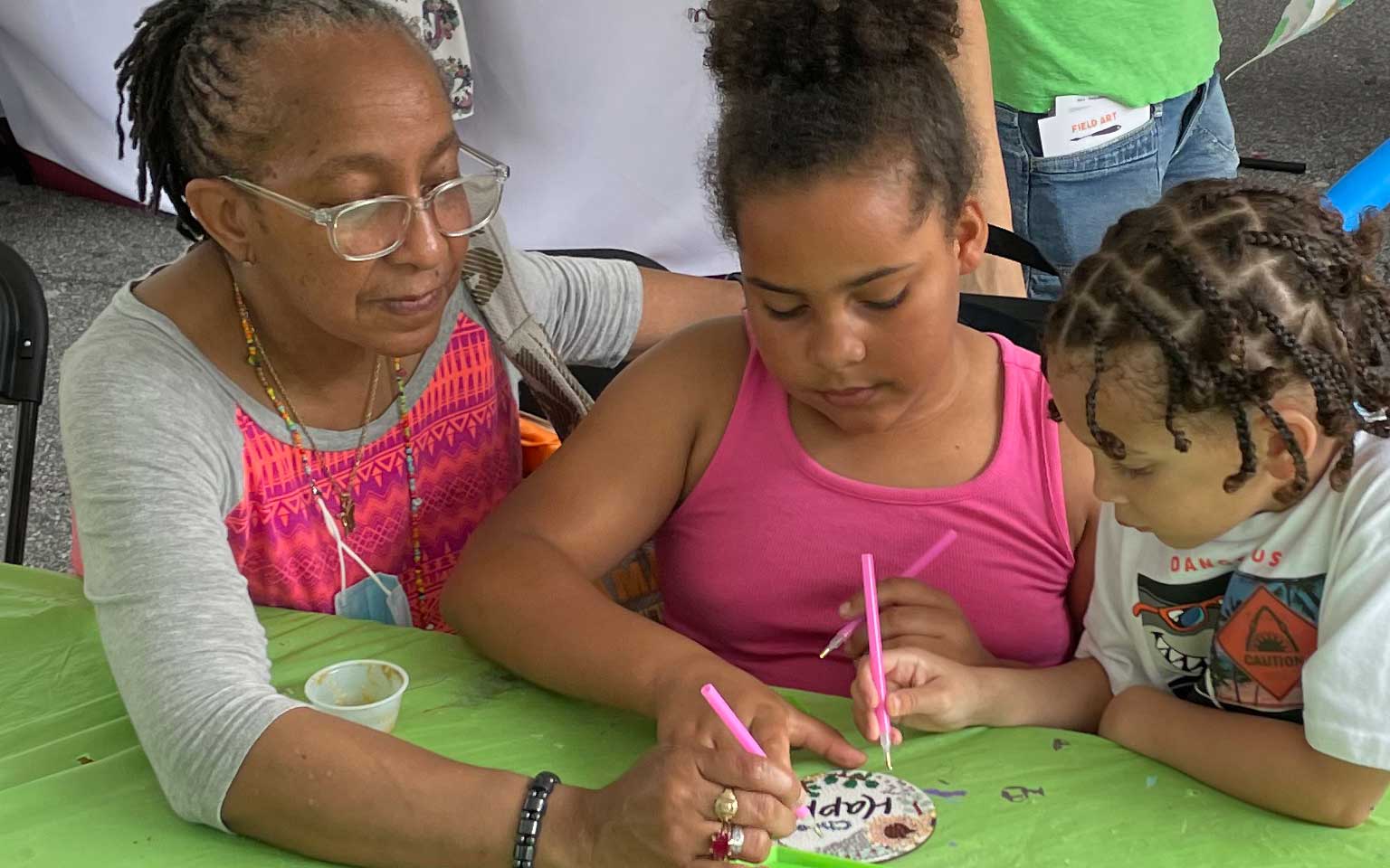 Families doing art together at a Greenville festival where USC Upstate featured our ART education program  