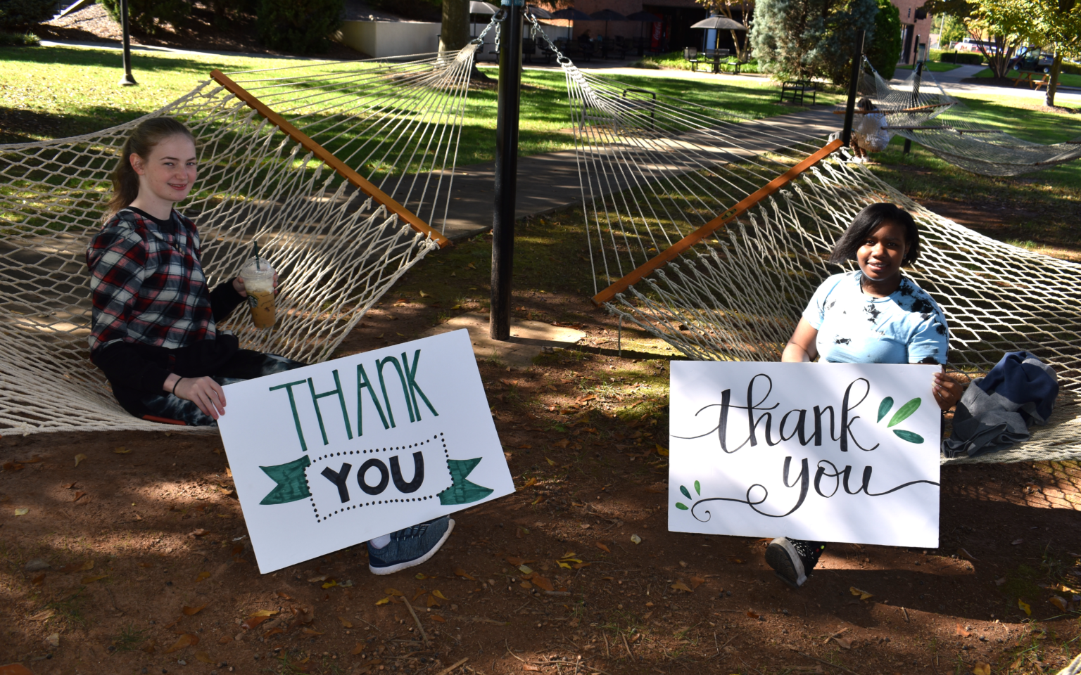 Students holding thank you signs