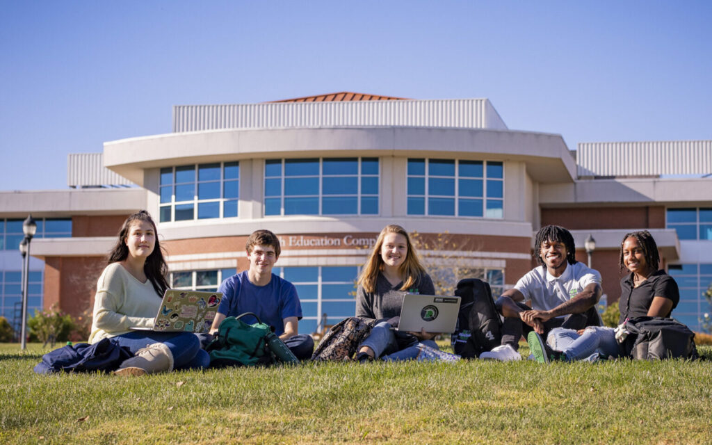Students sitting in front of a building