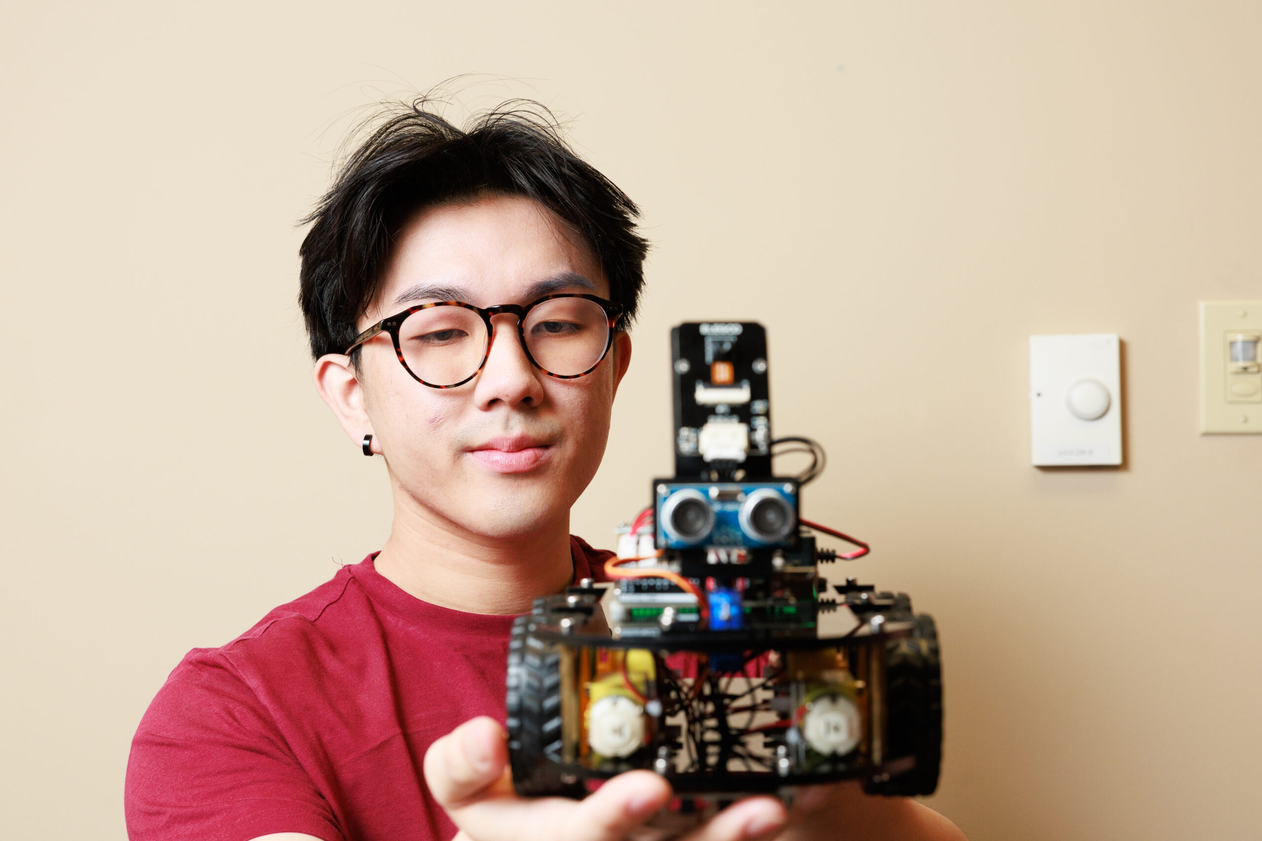 A student holding a robot