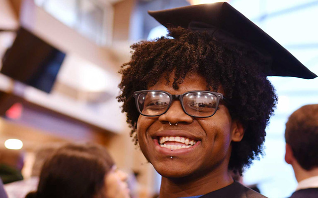 A graduate smiling