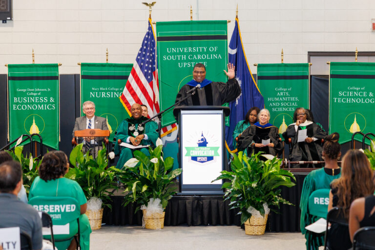 Dr. Russell Booker speaks at a podium