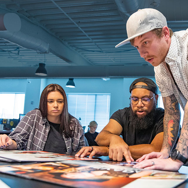 graphic design students looking at designs