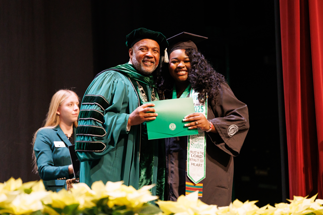Dr. Bennie Harris with Student at graduation