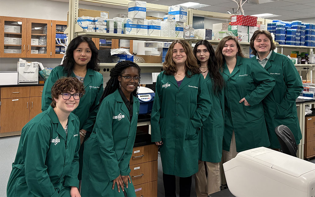 a group of students in lab coats