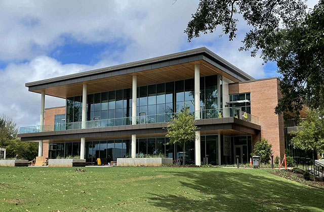 a building with lawn and trees