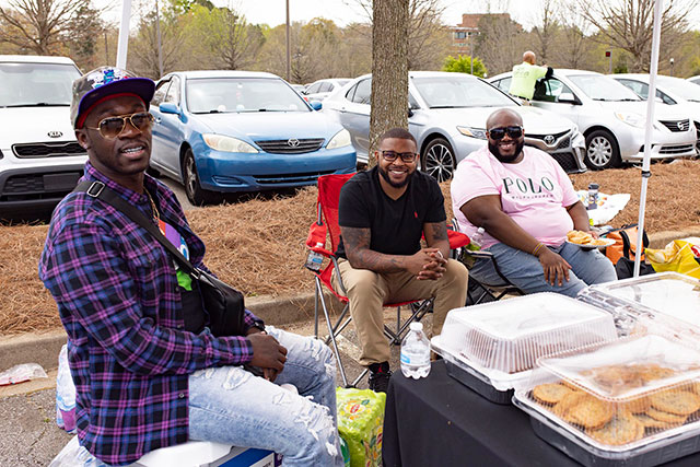 a group of men sitting outside