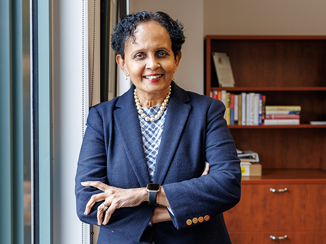 Image of Dr. Uma Gupta in her office with her arms folded
