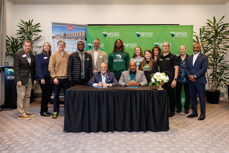 Photo of multiple people gathered around a table