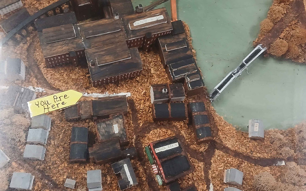 a model of a town with a yellow sign