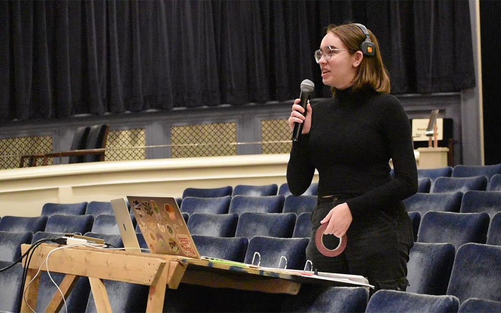 Avery Beaton stands with a microphone