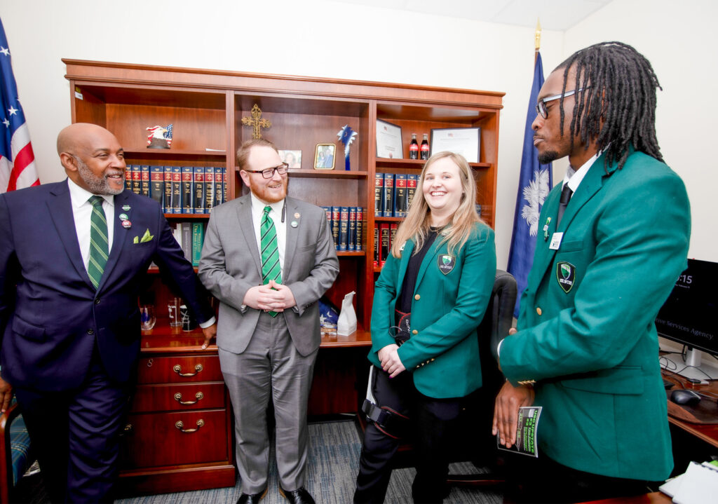 a group of people in suits smiling