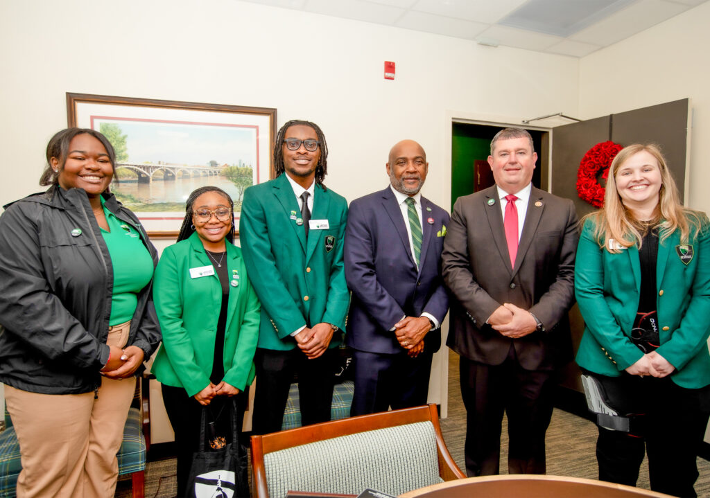 Dr. Harris poses with students at Carolina Day