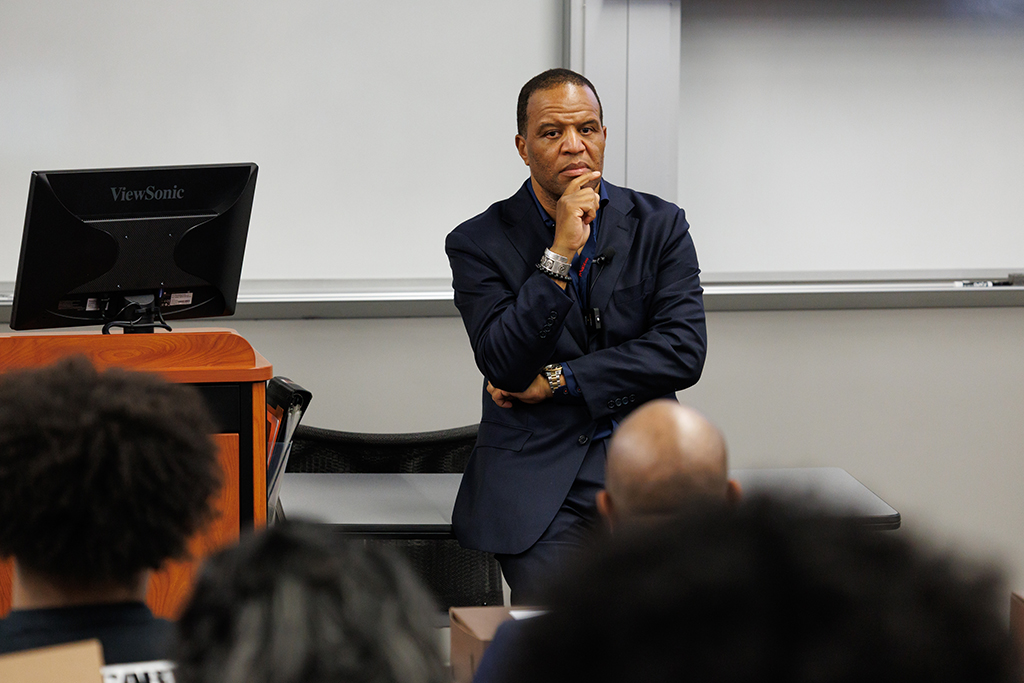 John Hope Bryant stands at the front of a room