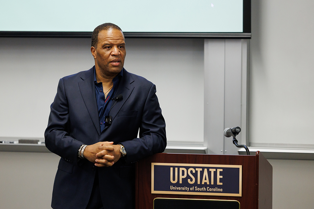 John Hope Bryant at a podium