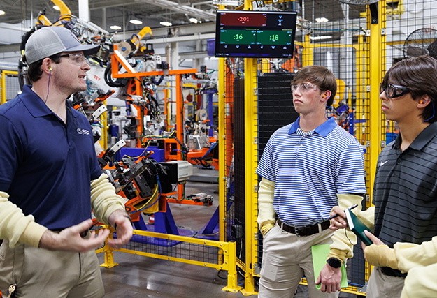 engineering students in a factory