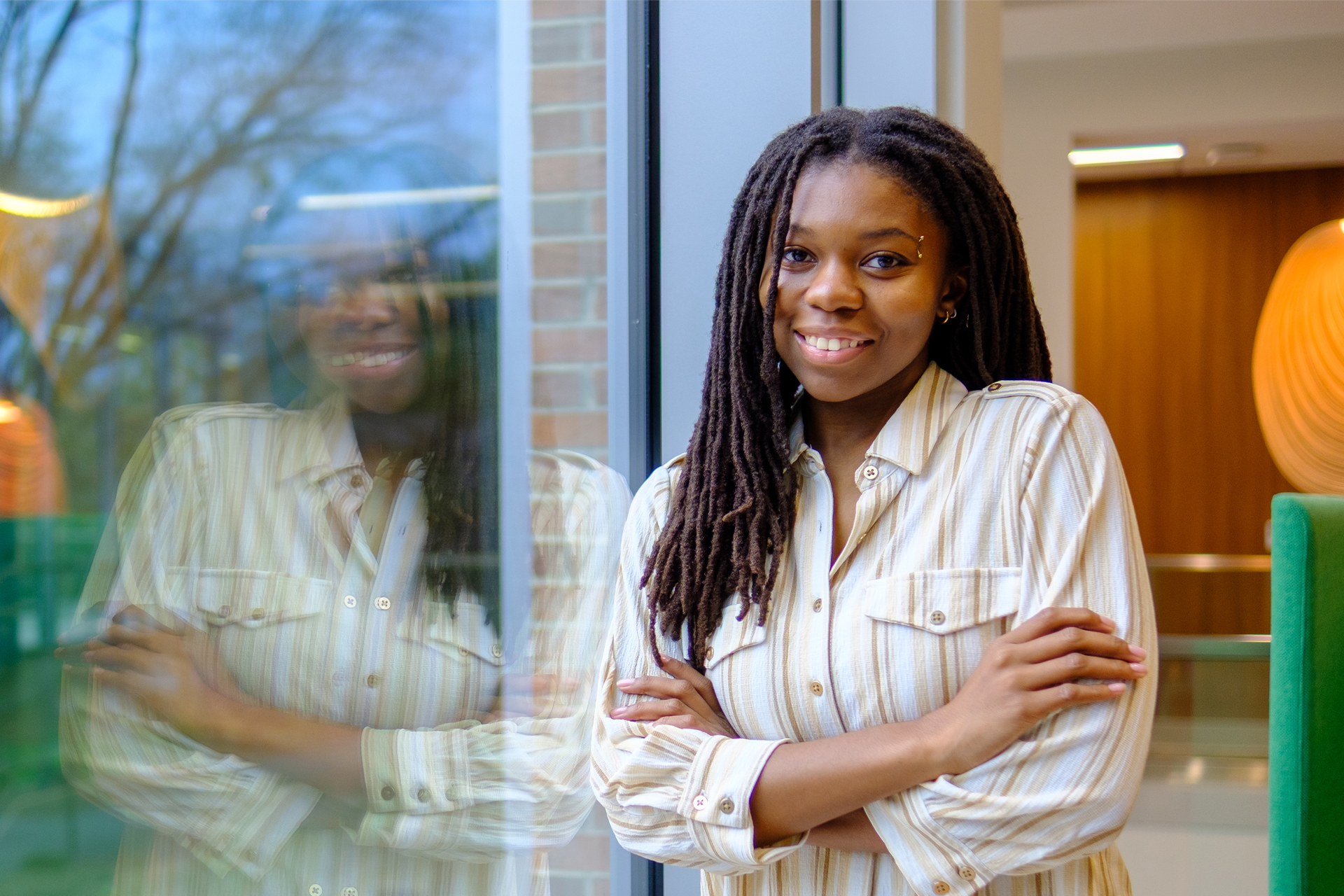 Arionna Grant poses by a window  