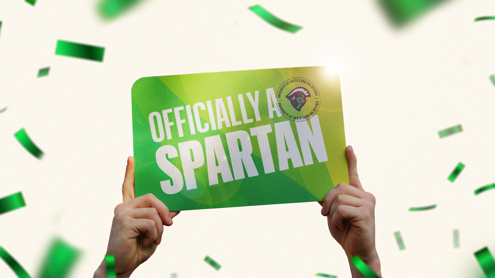 Hand holding a sign high in the air that reads 