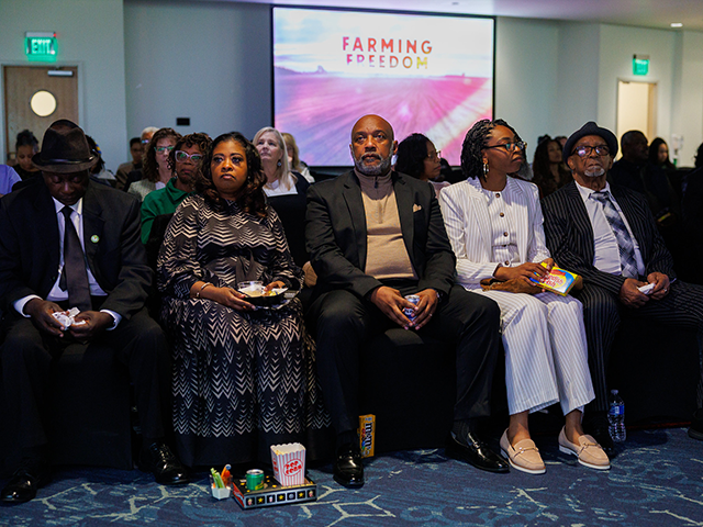 A group of people watch the film 'Farming Freedom' at the USC Upstate campus