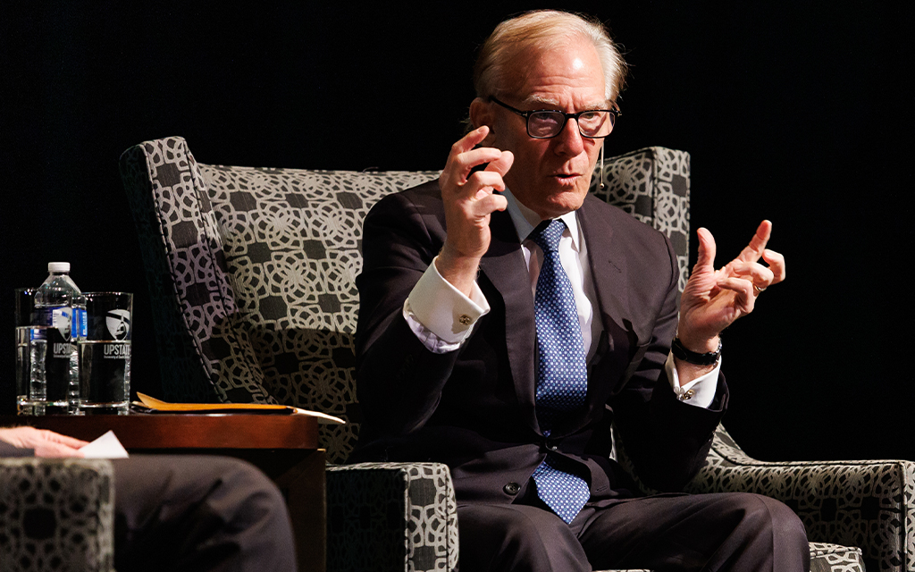 David Ignatius speaks with his hands raised