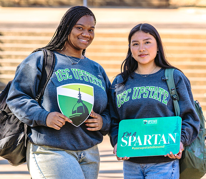 students with signs USC Upstate signs