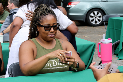 a woman plays a card game during alumni weekend