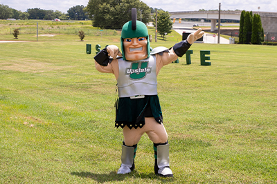 Sparty poses outside on campus